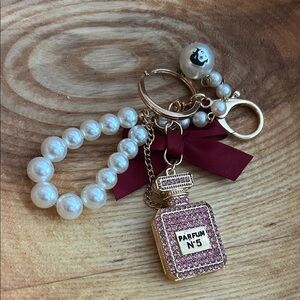 Elegant Pearl and Gold Keychain with Perfume Charm